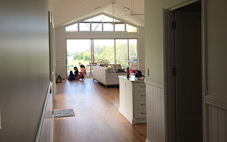 Interior of a newly-constructed residence showing family at play