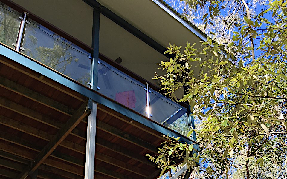 Exterior showing corner of a deck with glass ballustrades